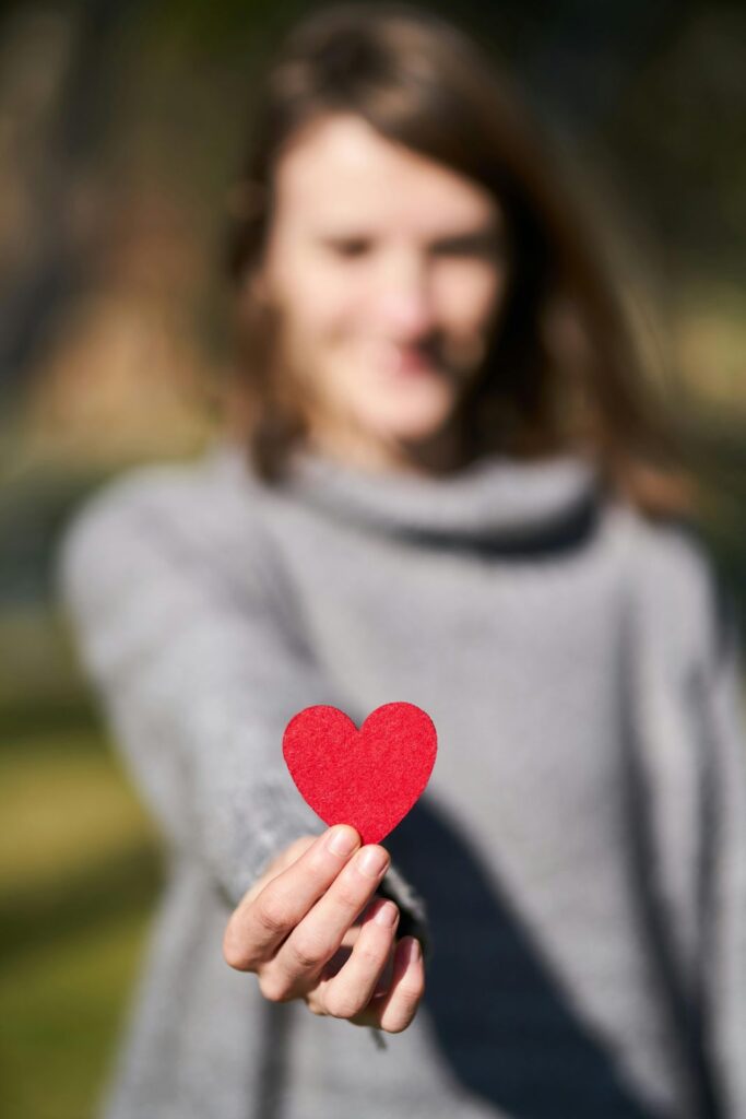 A woman holding a paper heart